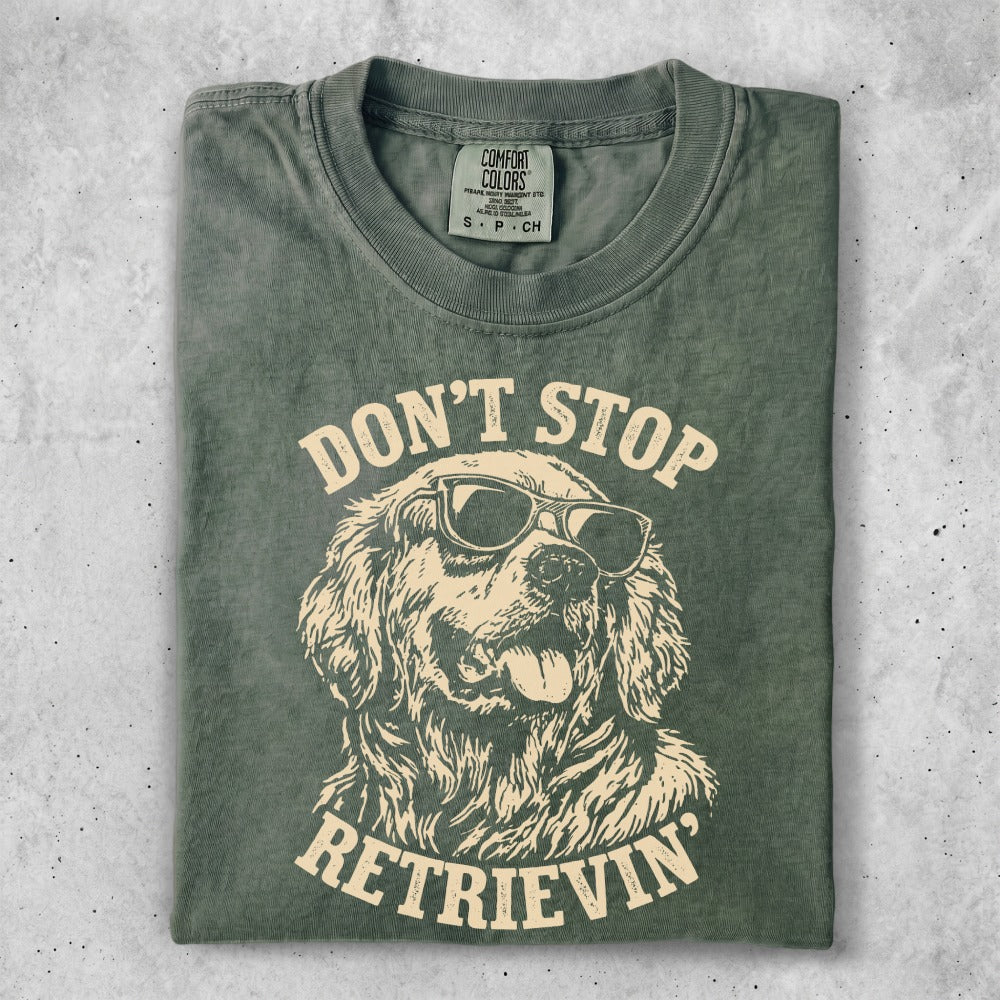 Green t-shirt with dog wearing sunglasses and text "Don't Stop Retrieving".