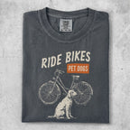 Charcoal t-shirt with "Ride Bikes Pet Dogs" graphic and dog with bicycle.