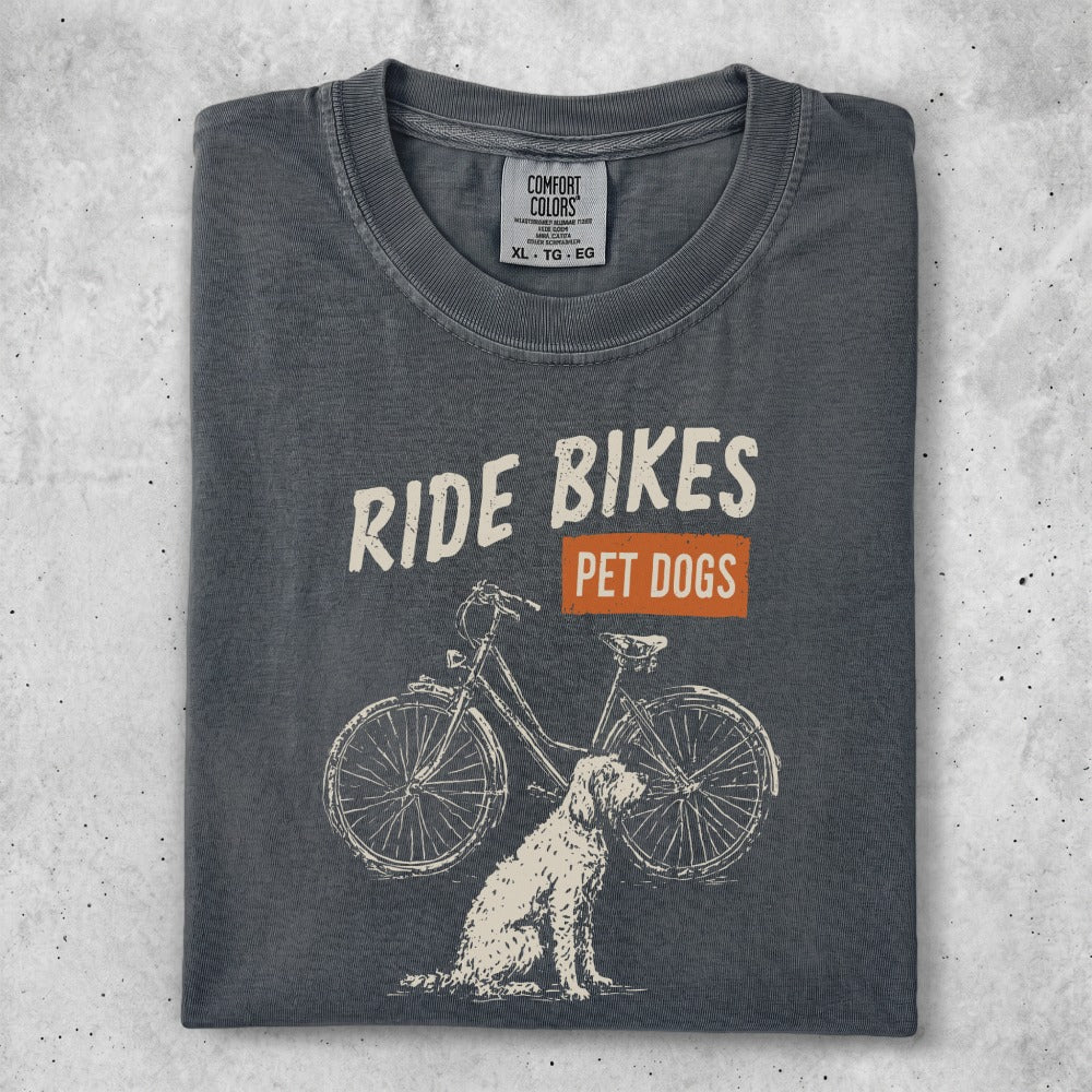 Charcoal t-shirt with "Ride Bikes Pet Dogs" graphic and dog with bicycle.