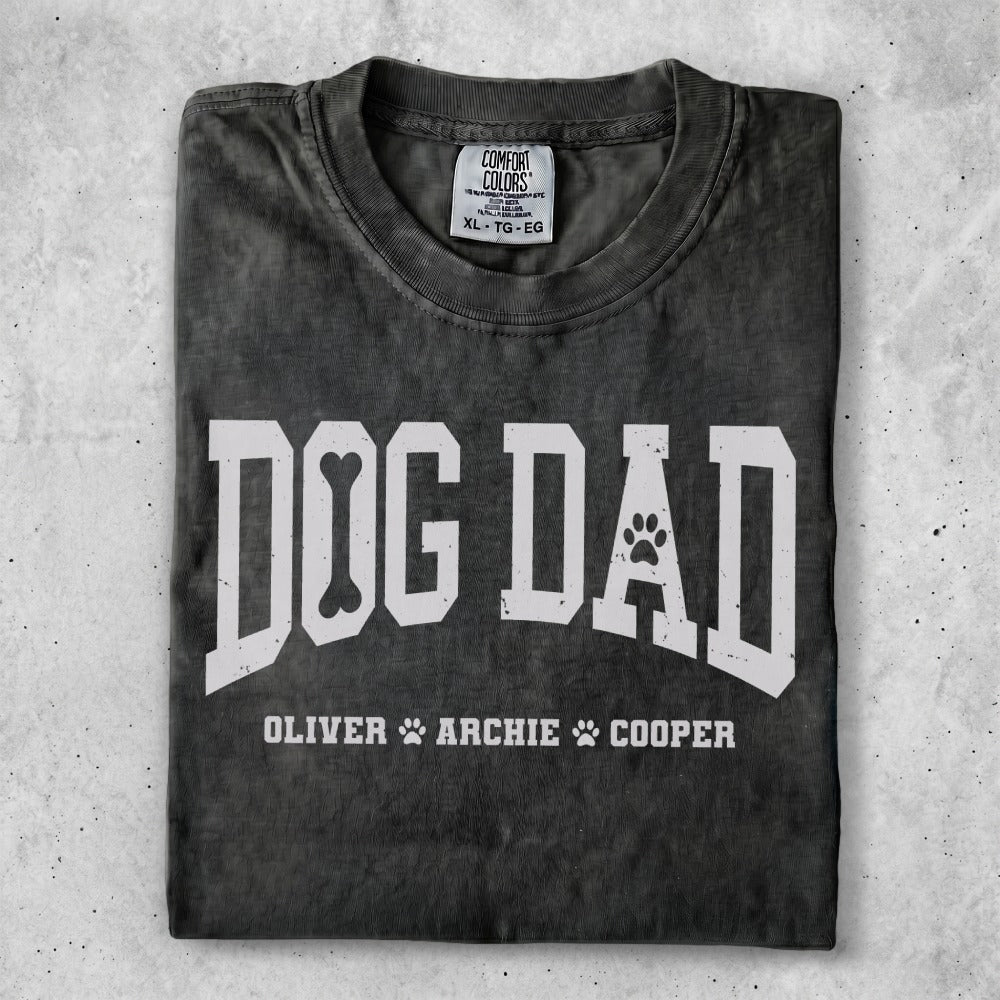 Black t-shirt with "DOG DAD" and paw print, names Oliver, Archie, Cooper.