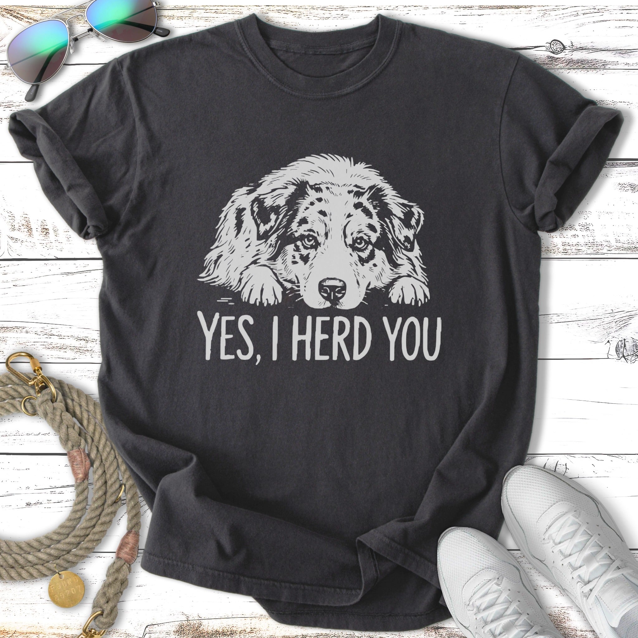 Dark t-shirt with a relaxed Australian Shepherd dog graphic and text "YES, I HERD YOU".