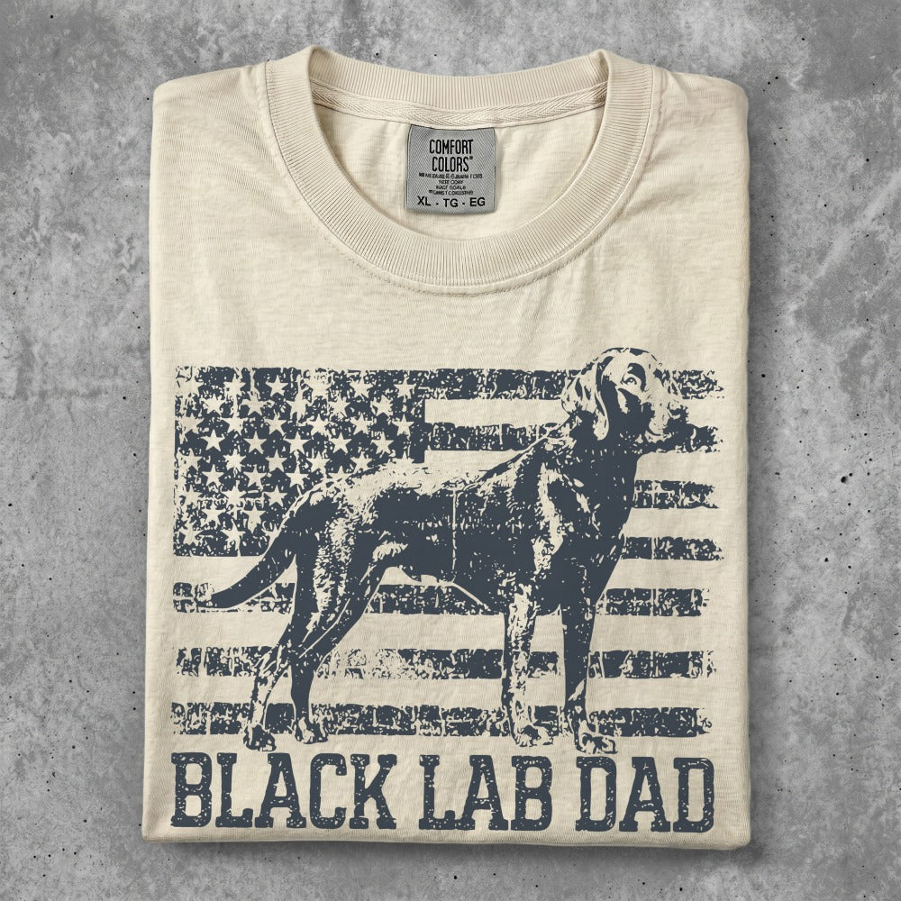 Cream t-shirt with distressed US flag and black Labrador graphic, "BLACK LAB DAD" text.