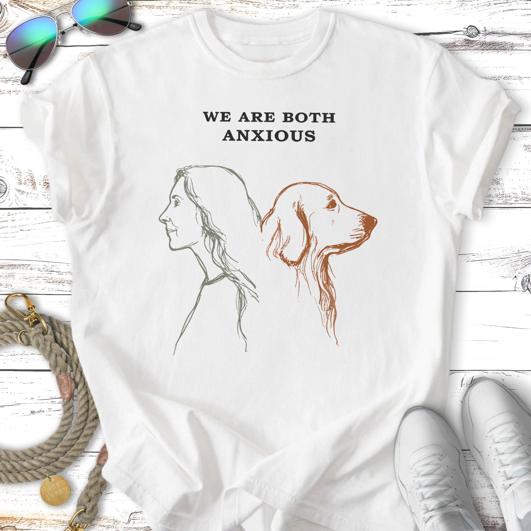White t-shirt with sketch of a woman and dog, text reads "WE ARE BOTH ANXIOUS".