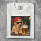 Golden retriever wearing sunglasses and a red cap drinks beer.