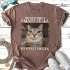 T-shirt with text "YOU'RE EITHER A SMART FELLA OR A FART SMELLA" and a cat's face.