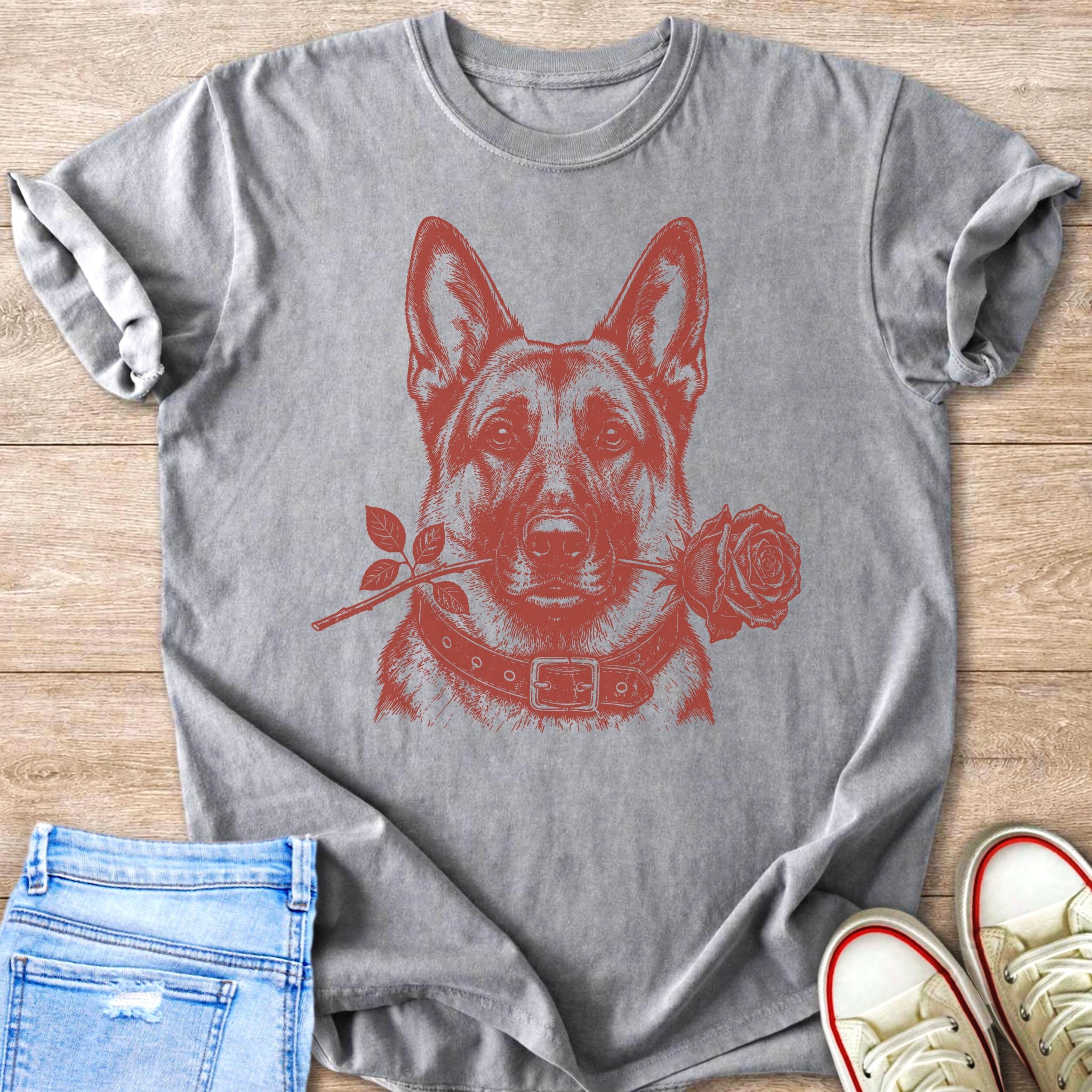 Grey t-shirt with a red German Shepherd and rose illustration, styled with jeans and sneakers.