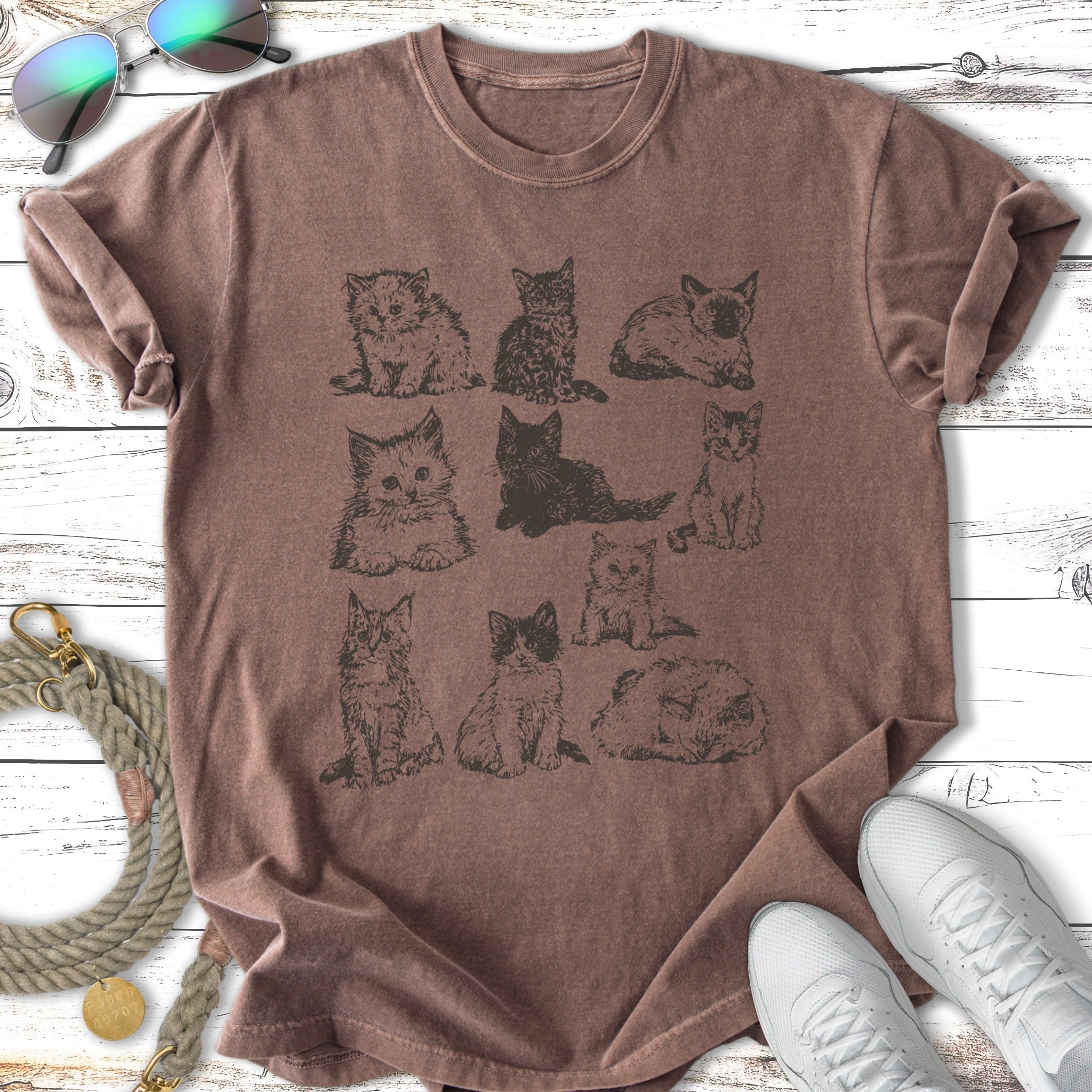 T-shirt with nine sketched kittens in rows of three.