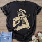 Black t-shirt with a tan graphic of a pug wearing a cowboy hat playing a guitar.