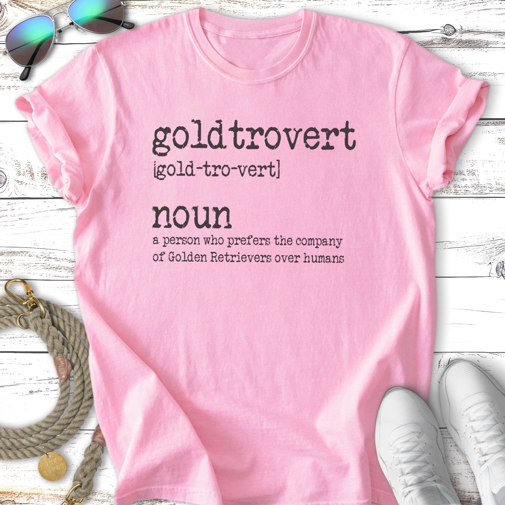 Pink t-shirt with "goldtrovert" definition: prefers Golden Retrievers over humans.