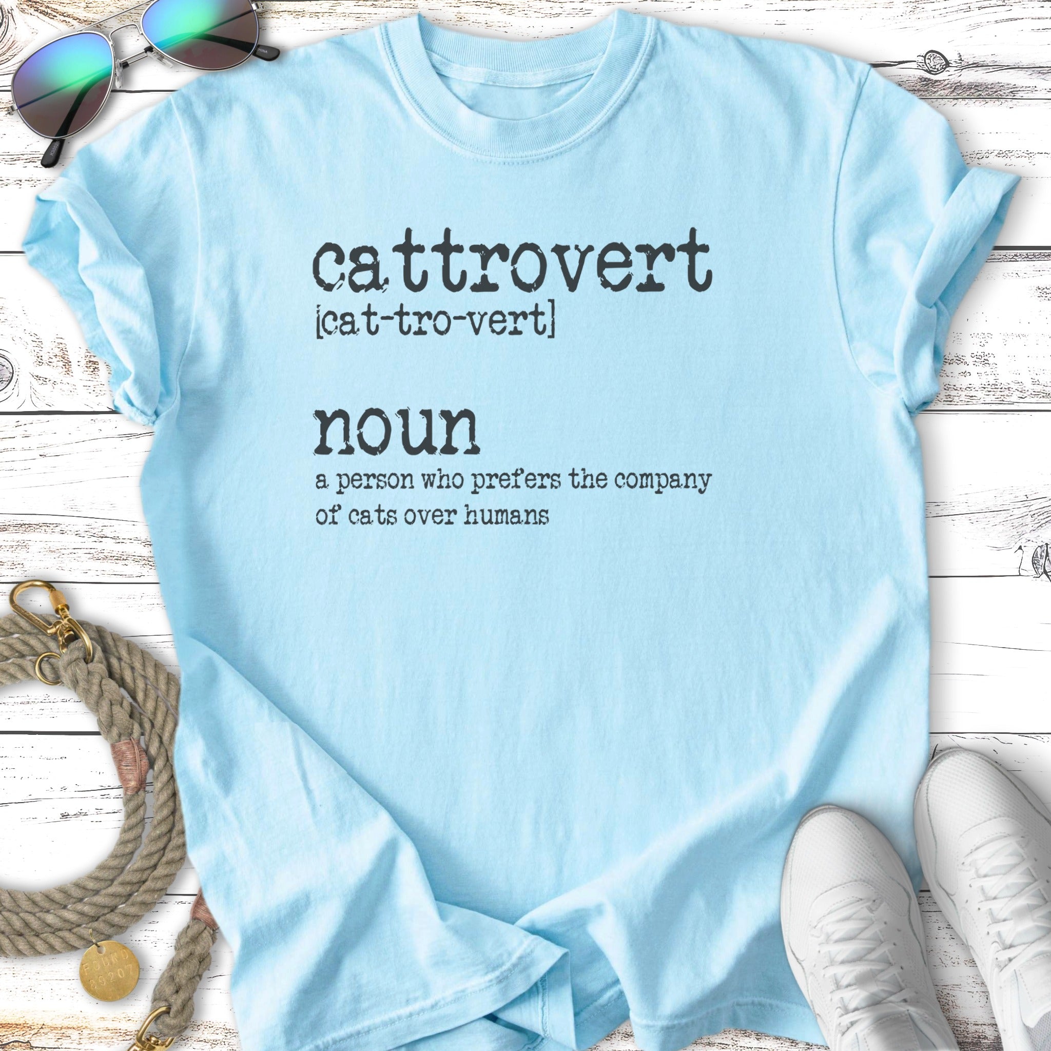 Light blue t-shirt with "cattrovert" and definition printed in black text.