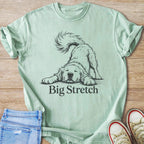 Light green t-shirt with a black line drawing of a dog stretching and the text "Big Stretch".