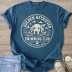 Blue t-shirt with print of Golden Retriever swimming, text "SWIMMING CLUB".