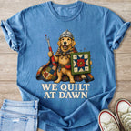 Golden retriever in knight armor holding a seam ripper and quilt with "We Quilt At Dawn" text.
