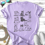 Nine different illustrated cats in a grid pattern on a lavender t-shirt.