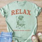 Mint t-shirt with "RELAX" and pug in a chair graphic.