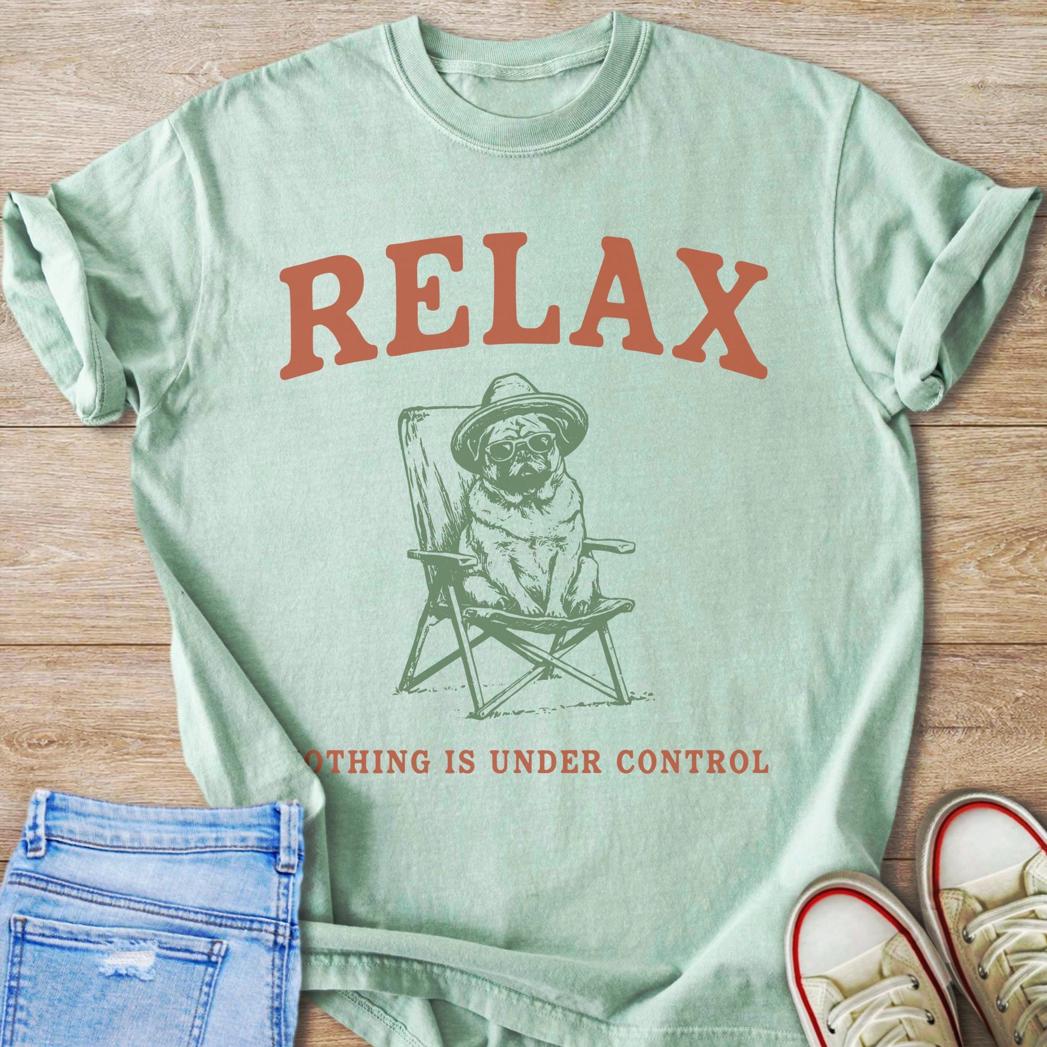 Mint t-shirt with "RELAX" and pug in a chair graphic.