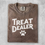 T-shirt with "Treat Dealer" and a paw print graphic.