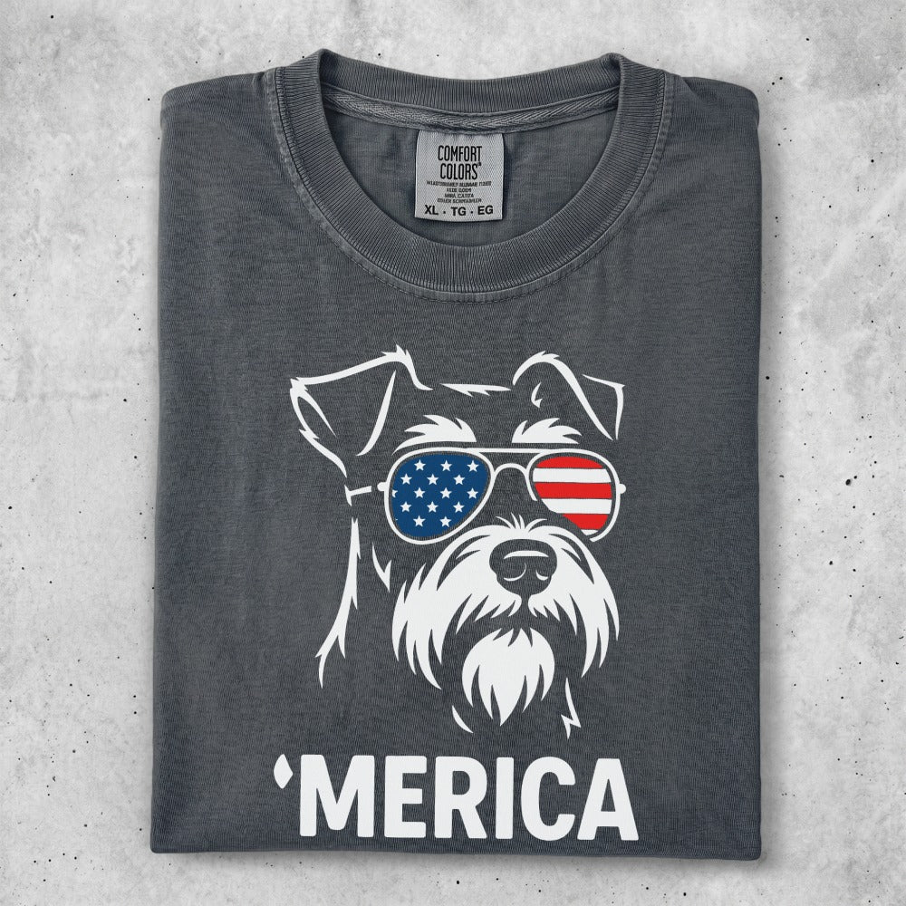 Schnauzer wearing American flag sunglasses with "Merica" text.