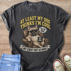 French bulldog in armchair with sunglasses holding mug, text "At least my dog thinks I'm cool."