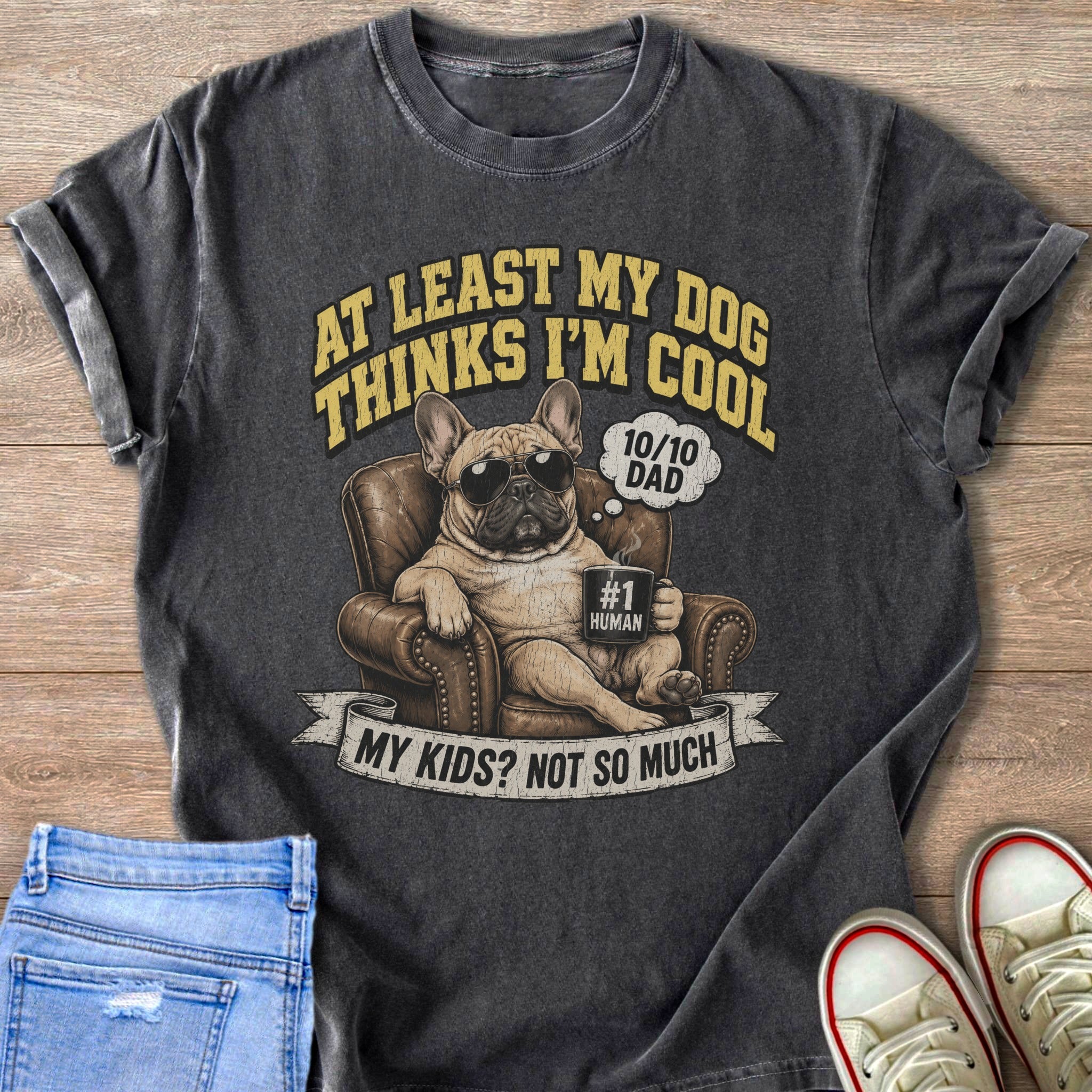French bulldog in armchair with sunglasses holding mug, text "At least my dog thinks I'm cool."
