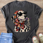 Dalmatian dog wearing sunglasses and a colorful crochet scarf, holding a crochet hook and yarn.