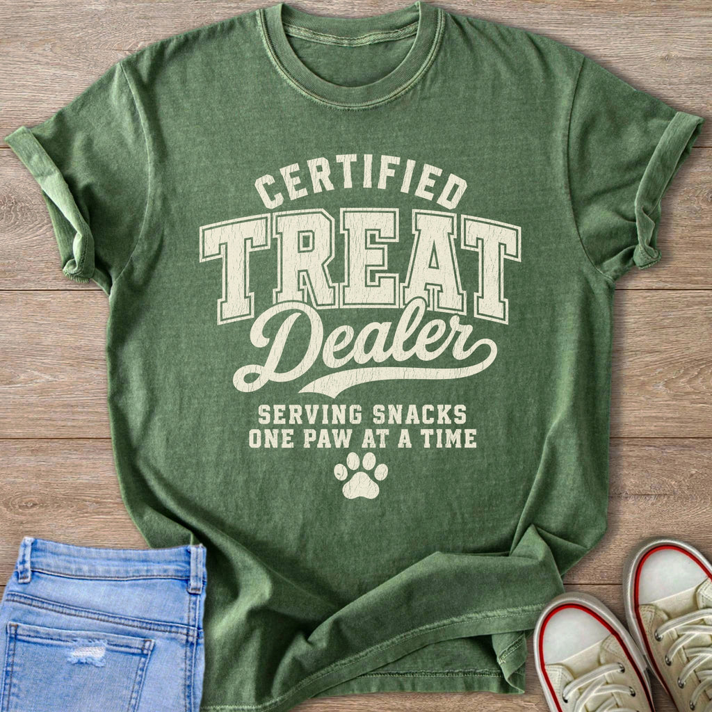 Green t-shirt with "Certified Treat Dealer Serving Snacks One Paw at a Time" text.