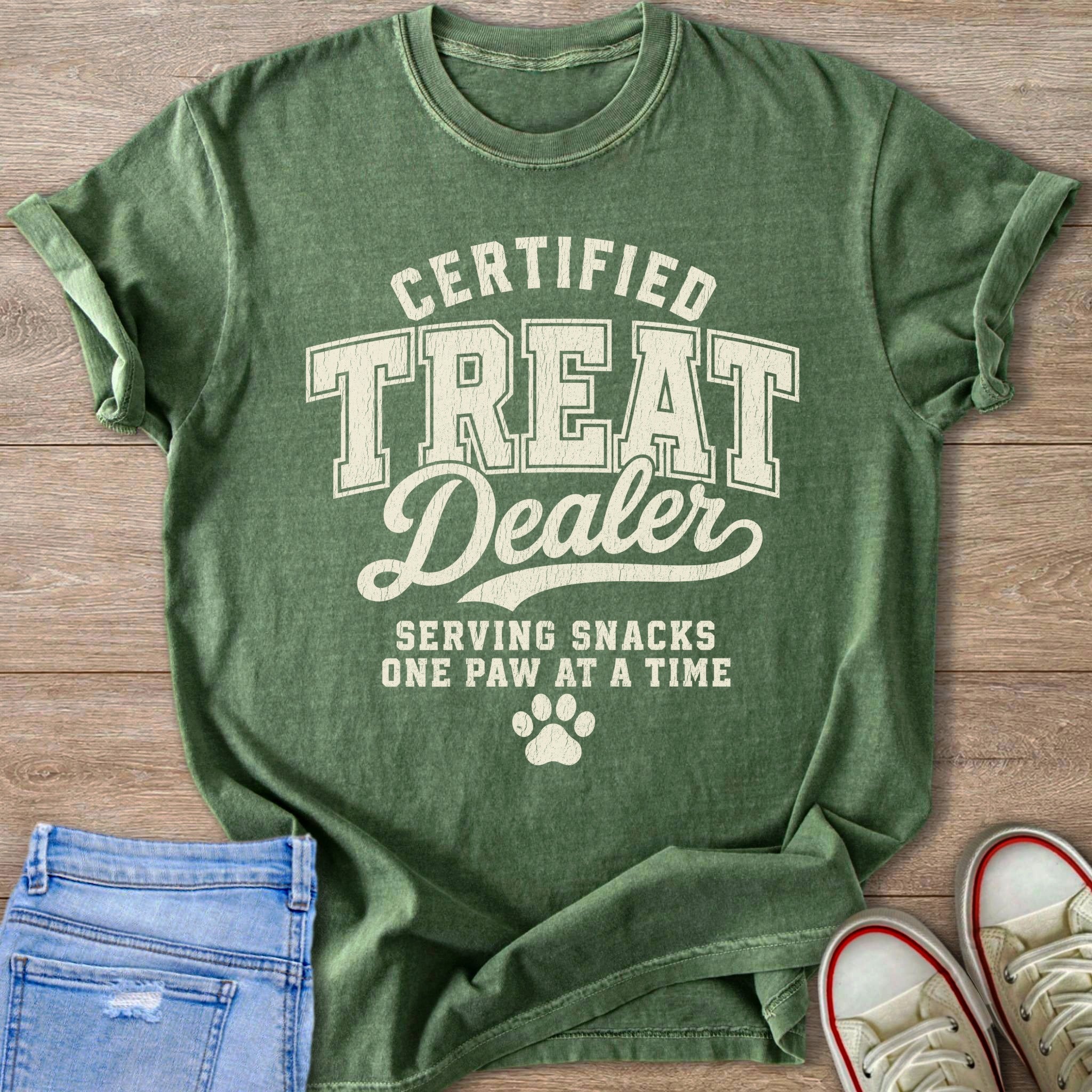 Green t-shirt with "Certified Treat Dealer Serving Snacks One Paw at a Time" text.