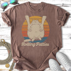 T-shirt with cartoon cat being hugged and "Rolling Fatties" text.