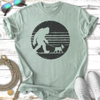 Bigfoot walking a small dog on a leash, vintage distressed circle graphic.