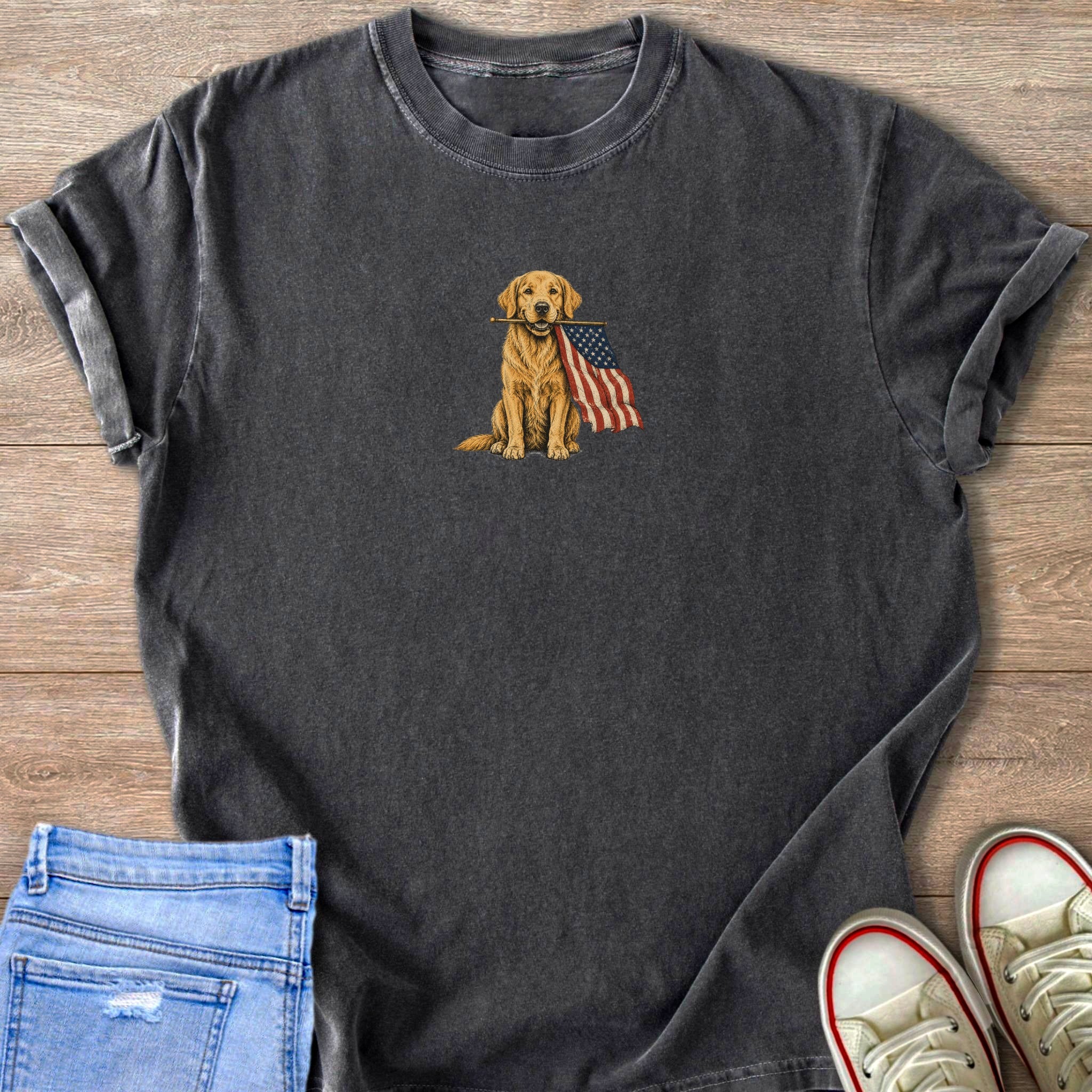 Dark gray t-shirt with a sitting golden retriever holding the American flag in its mouth.