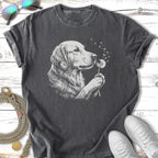 Golden Retriever dog blowing dandelion seeds on a dark t-shirt.