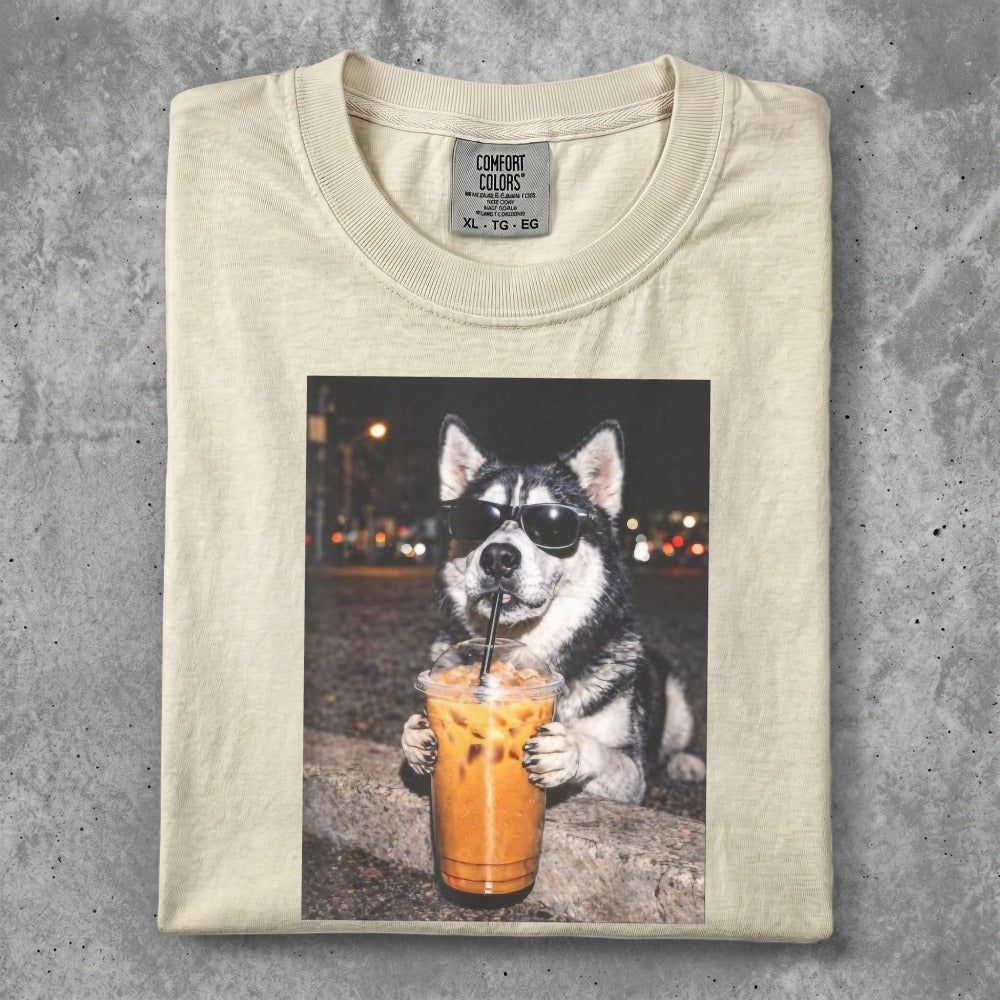 Husky dog wearing sunglasses holds a large iced coffee drink.