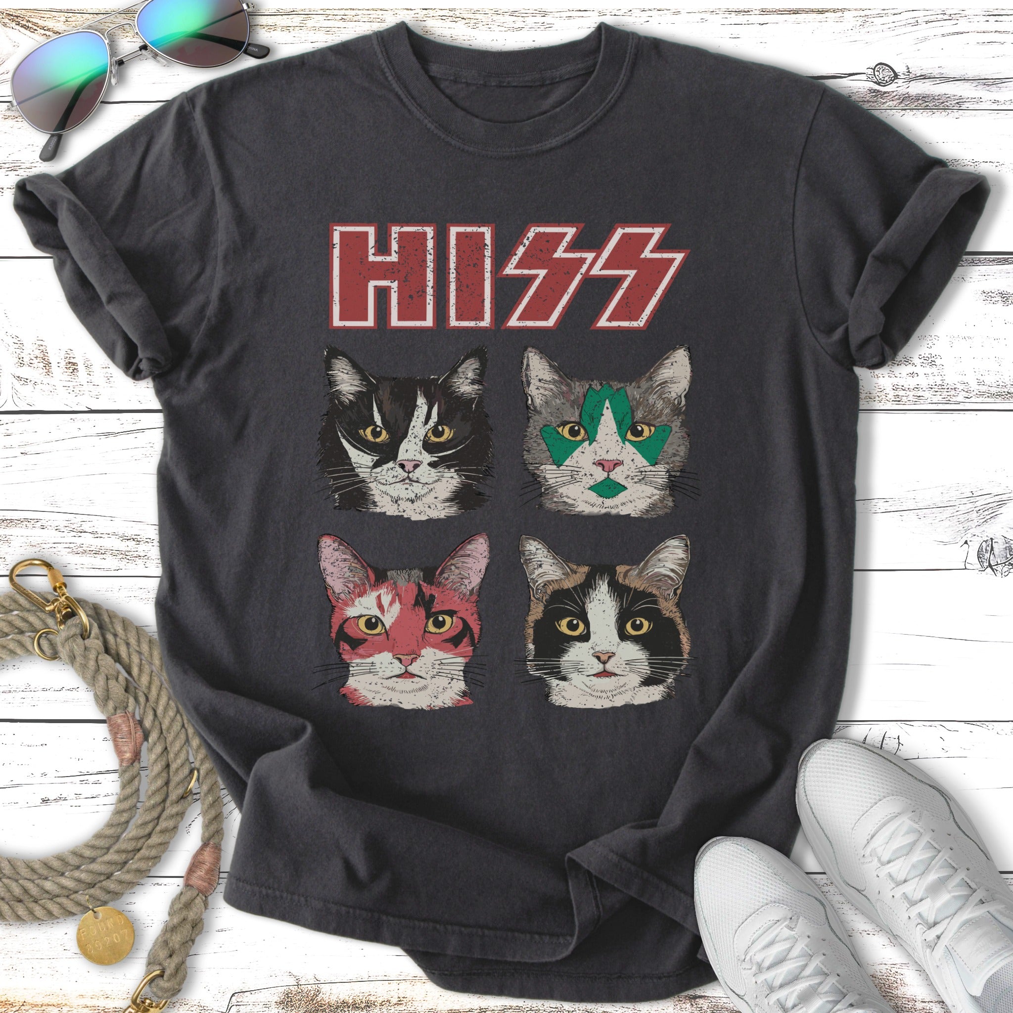 Four cats with KISS band makeup on a dark t-shirt.