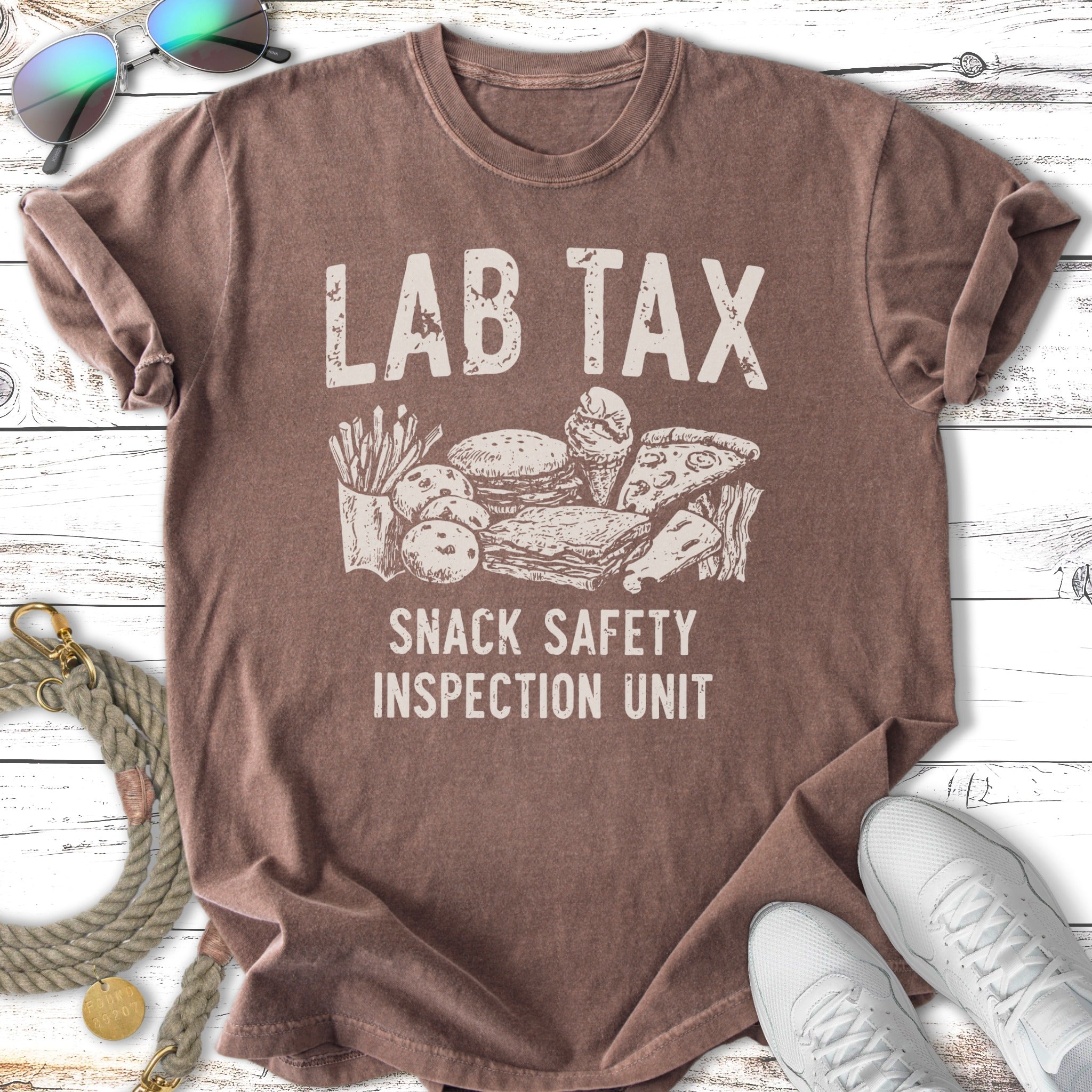 T-shirt with "Lab Tax Snack Safety Inspection Unit" and illustrations of snacks.