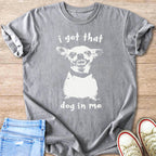 Grey t-shirt with white print of a dog's face and "i got that dog in me".