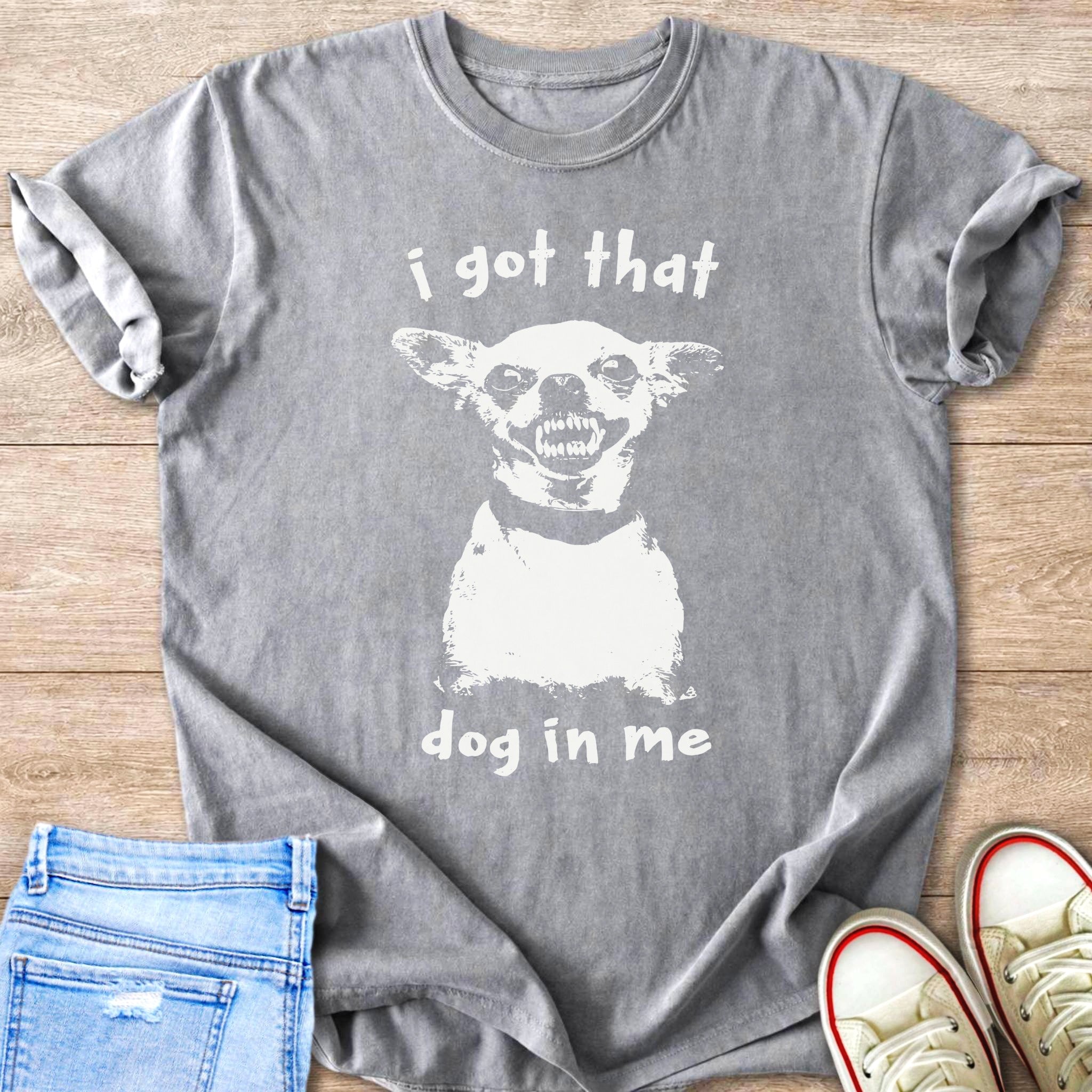 Grey t-shirt with white print of a dog's face and "i got that dog in me".