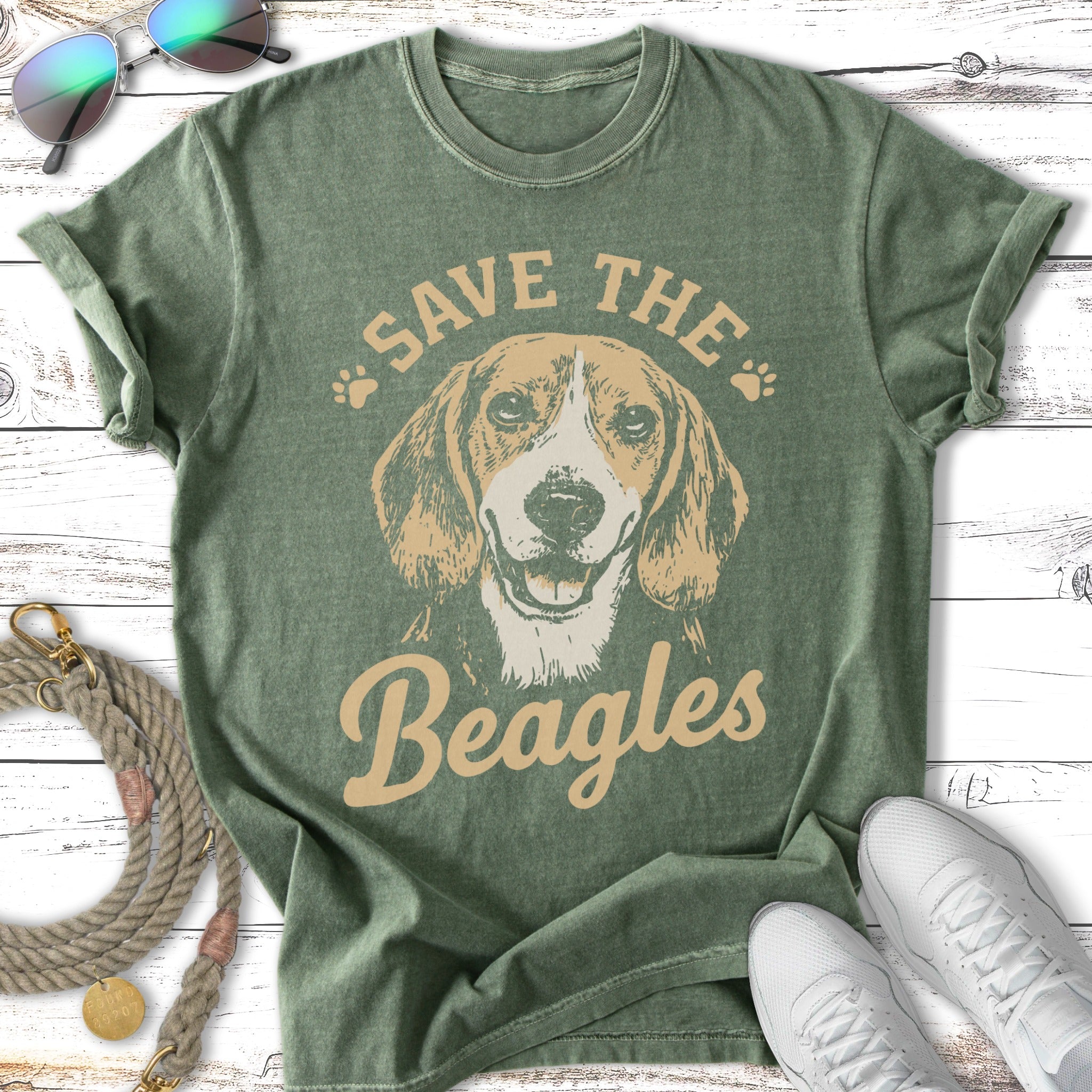 Green t-shirt with a graphic of a beagle dog and text "Save the Beagles".