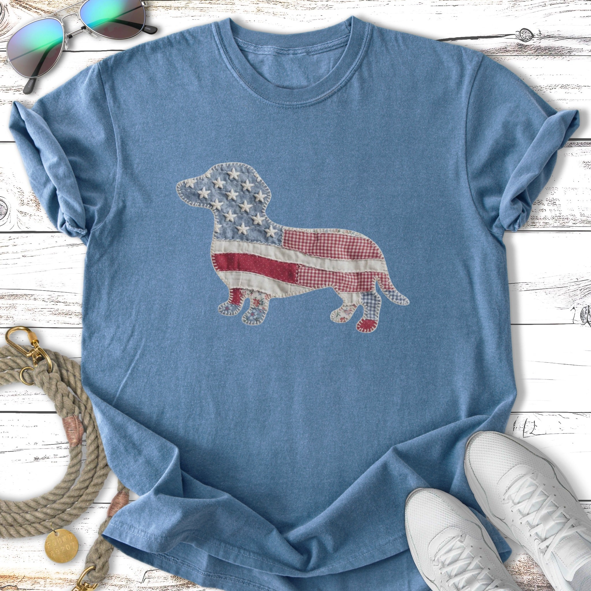 Blue t-shirt with a dachshund silhouette made of American flag fabric.