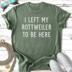 Green t-shirt with white text "I LEFT MY ROTTWEILER TO BE HERE".