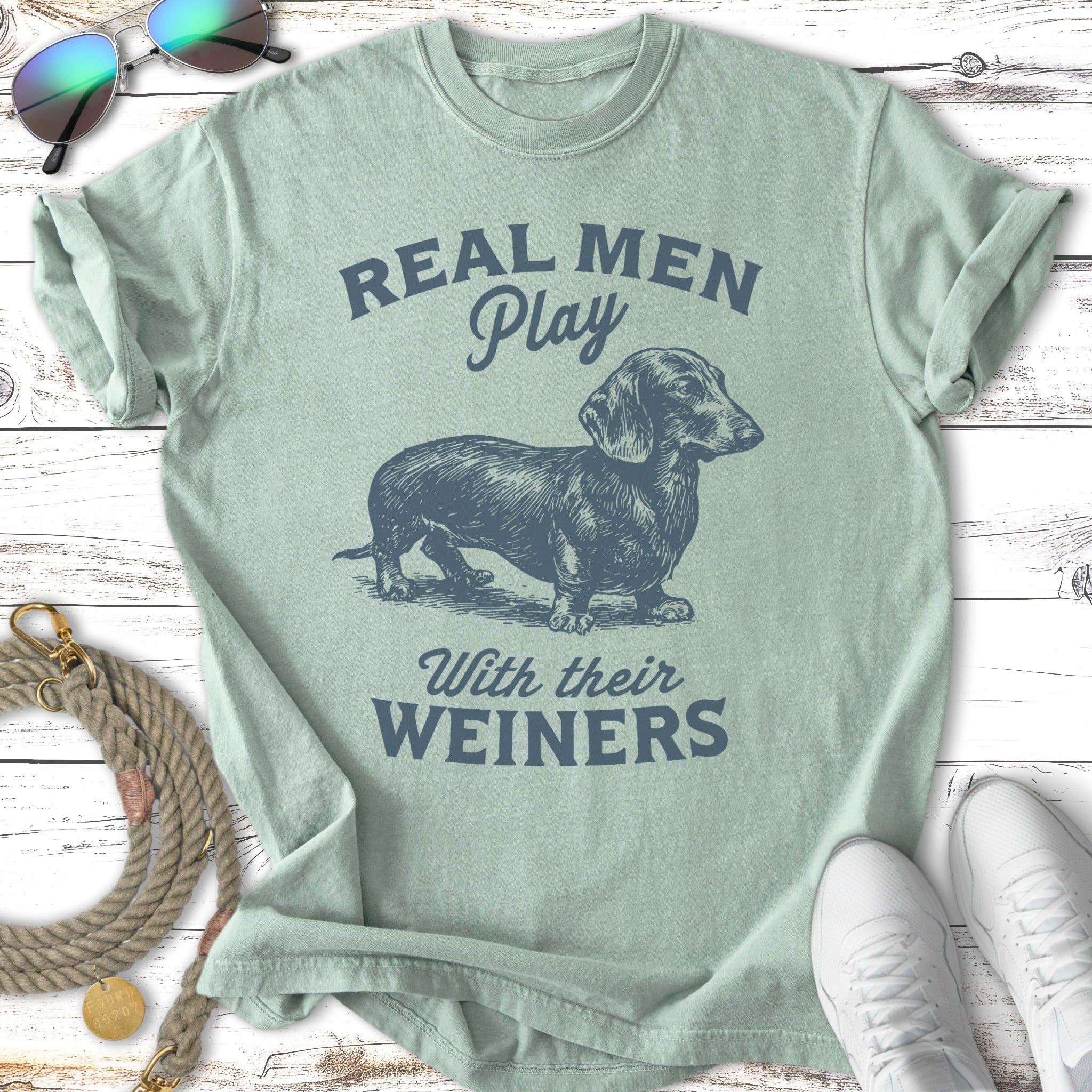 Light green t-shirt with dachshund and text "Real Men Play With Their Weiners".