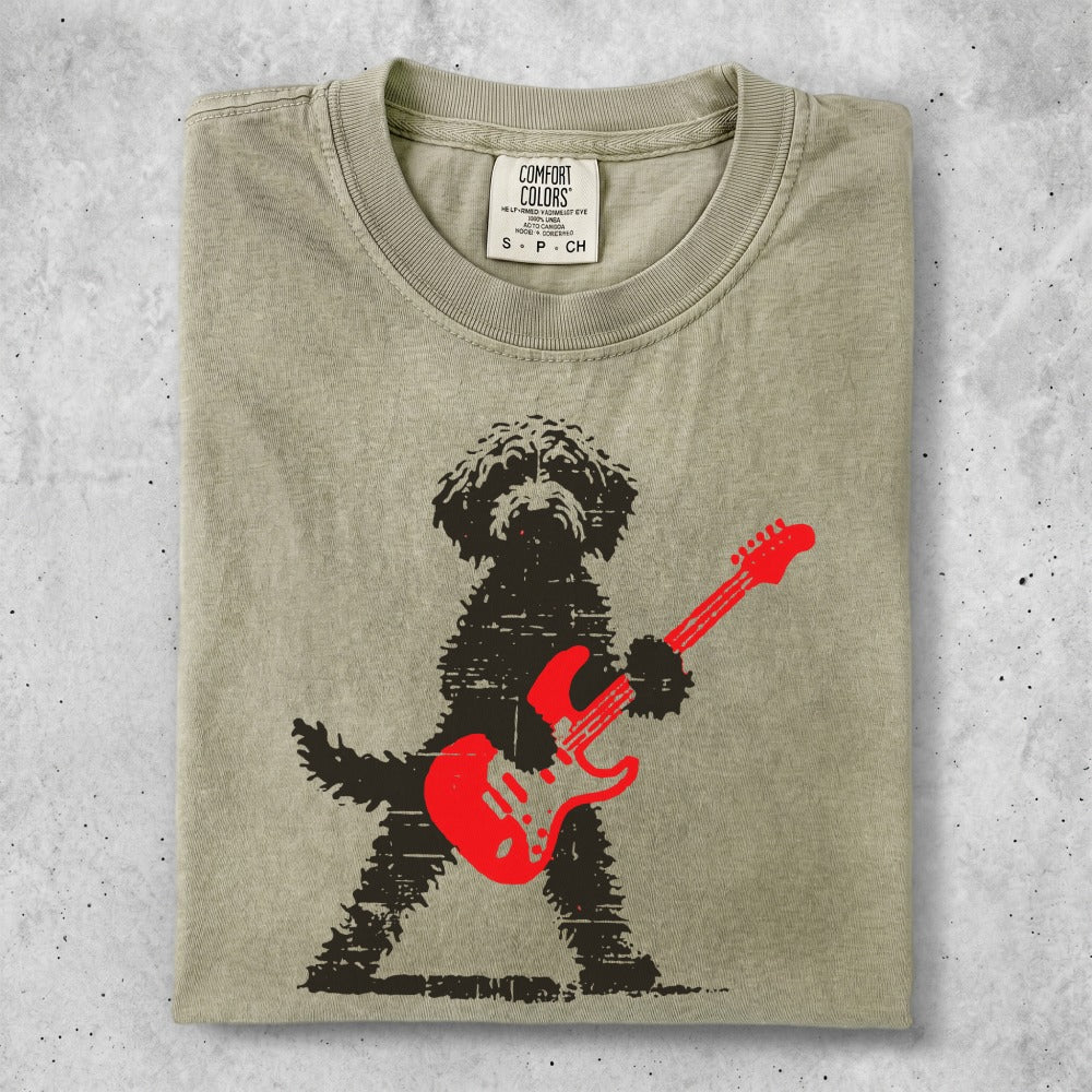 Black dog with red electric guitar, Comfort Colors shirt tag visible.