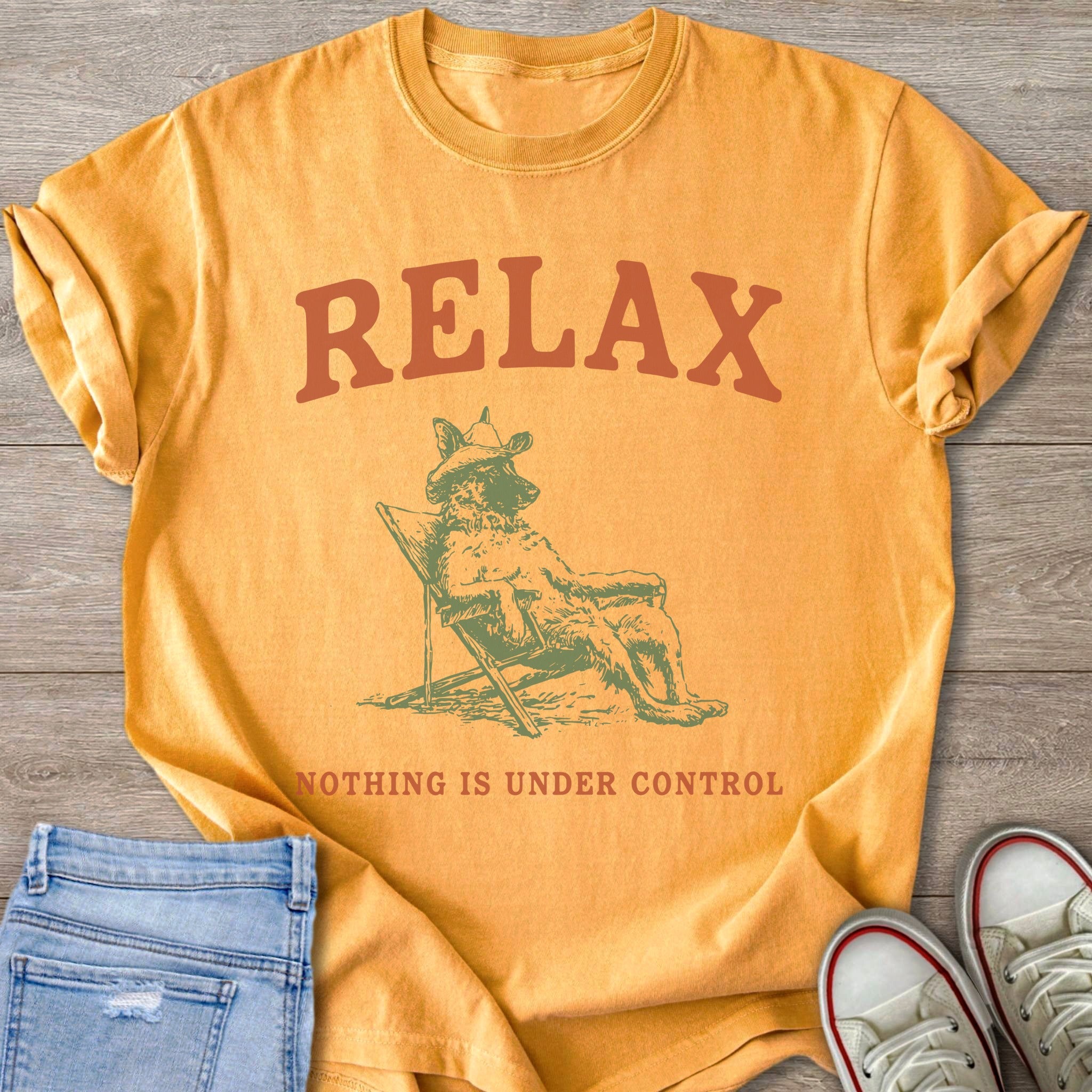 Orange t-shirt with "RELAX" and a dog in a chair, "NOTHING IS UNDER CONTROL".