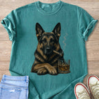 German Shepherd with cigar and whiskey on teal t-shirt.