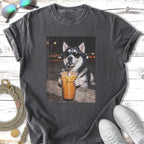 Husky dog wearing sunglasses drinks iced coffee with straw.