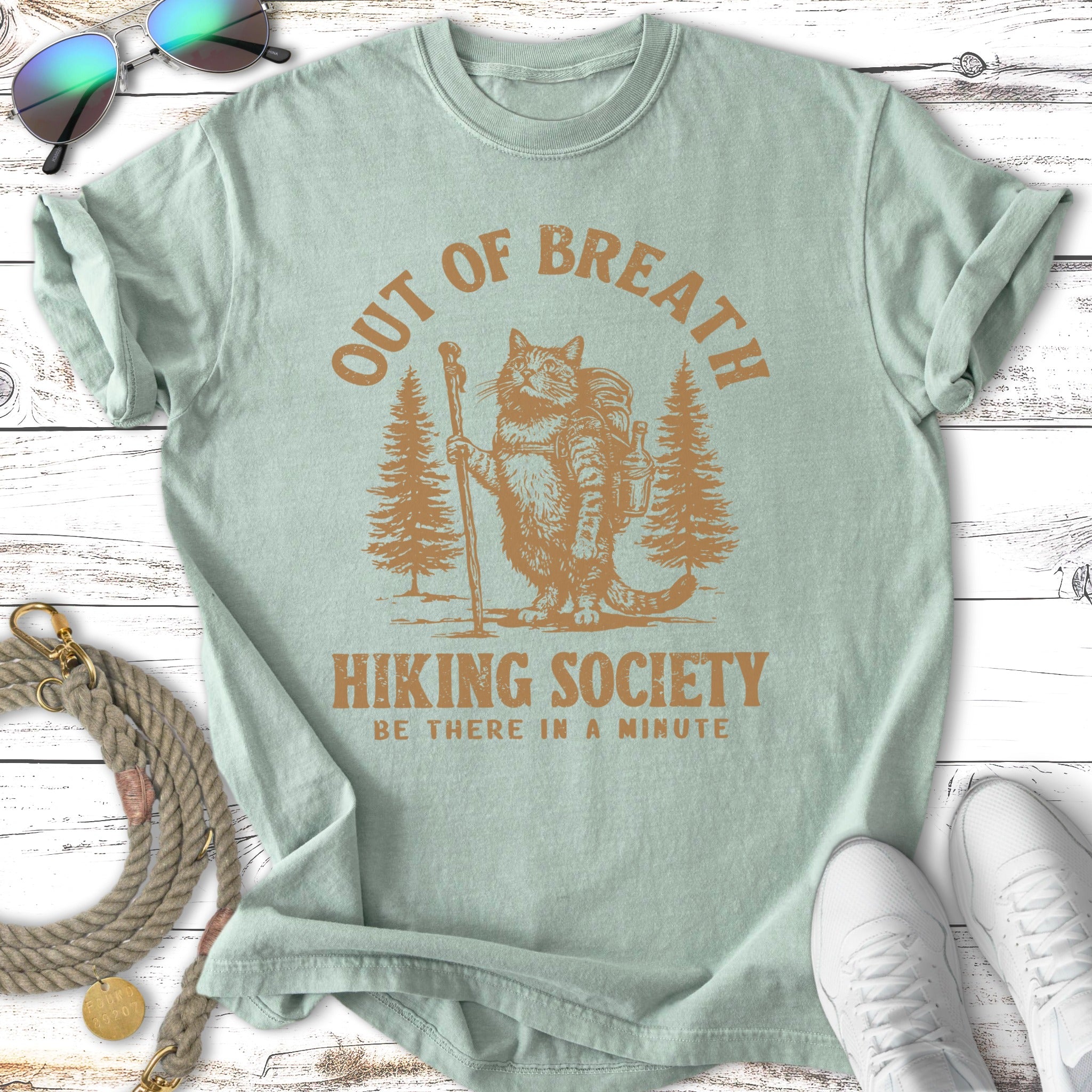 Cat with backpack and walking stick, "OUT OF BREATH HIKING SOCIETY" text.