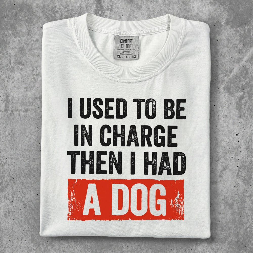 White t-shirt with "I USED TO BE IN CHARGE THEN I HAD A DOG" text.