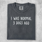 Dark gray t-shirt with white text reading "I WAS NORMAL 3 DOGS AGO".