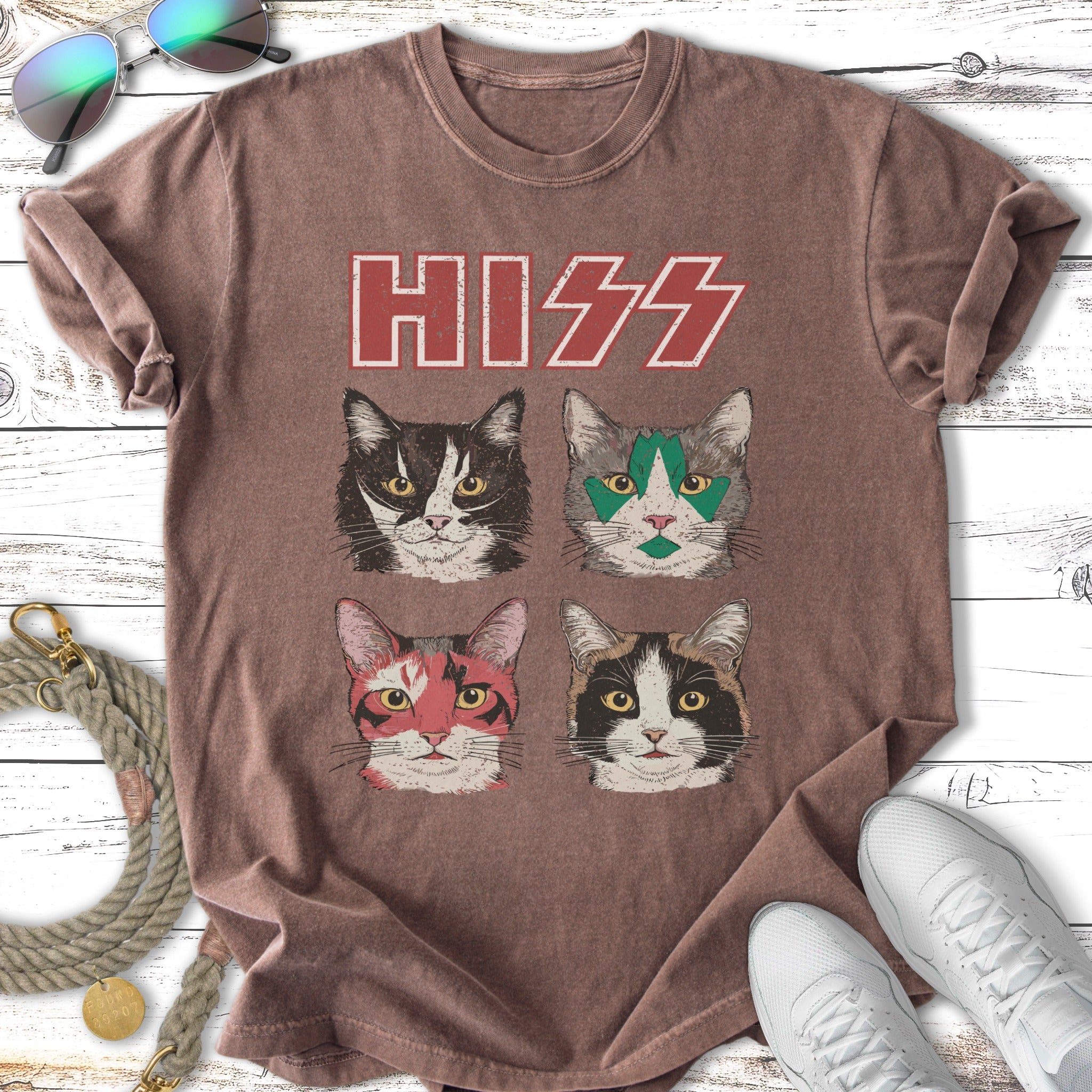 Four cats with stylized makeup on a distressed t-shirt.
