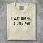 Cream t-shirt with "I WAS NORMAL 3 DOGS AGO" text in black.