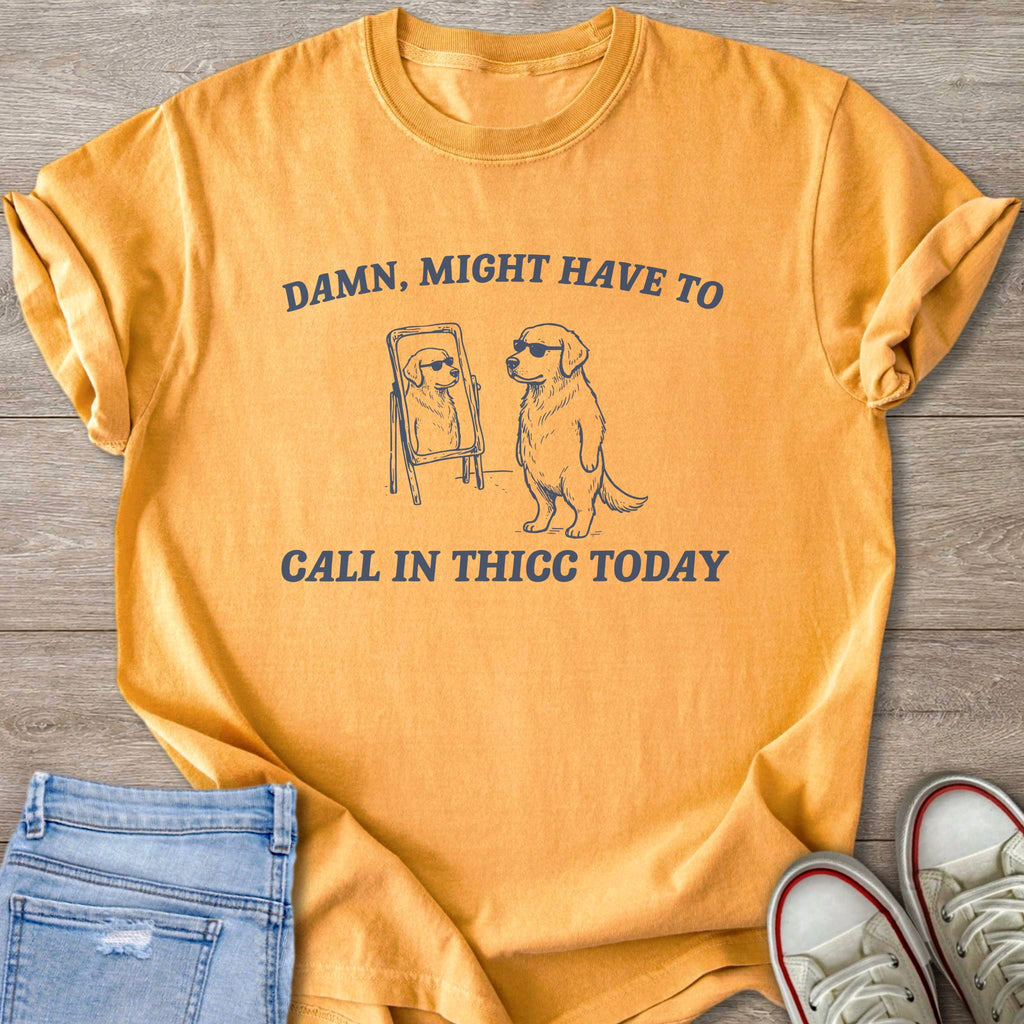 Orange t-shirt with golden retriever graphic and text: "DAMN, MIGHT HAVE TO CALL IN THICC TODAY".